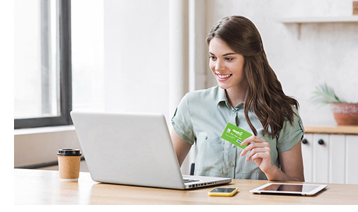 woman smiling about how easy it is to use her APGFCU credit union credit card for online shopping