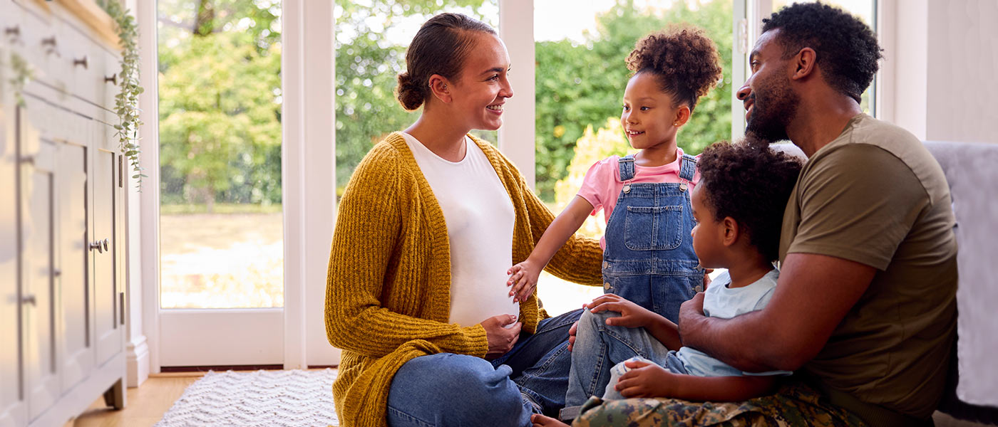 Family sitting together after buying an APGFCU VA Mortgage Loan